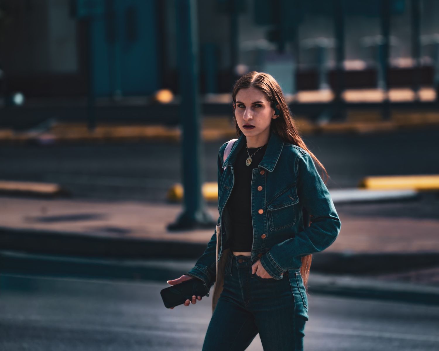 Cute girl walking on an urban street at dusk. At the Tx capital. Captured by a Seguin photographer at grain n glass