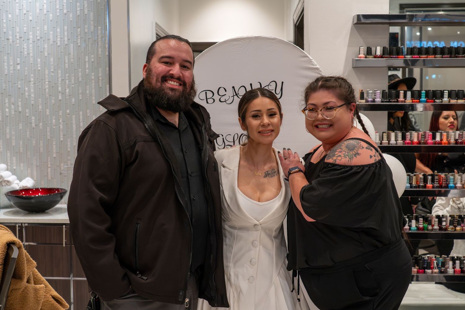 Candid moments captured in a salon setting with white balloons and beauty product displays.
