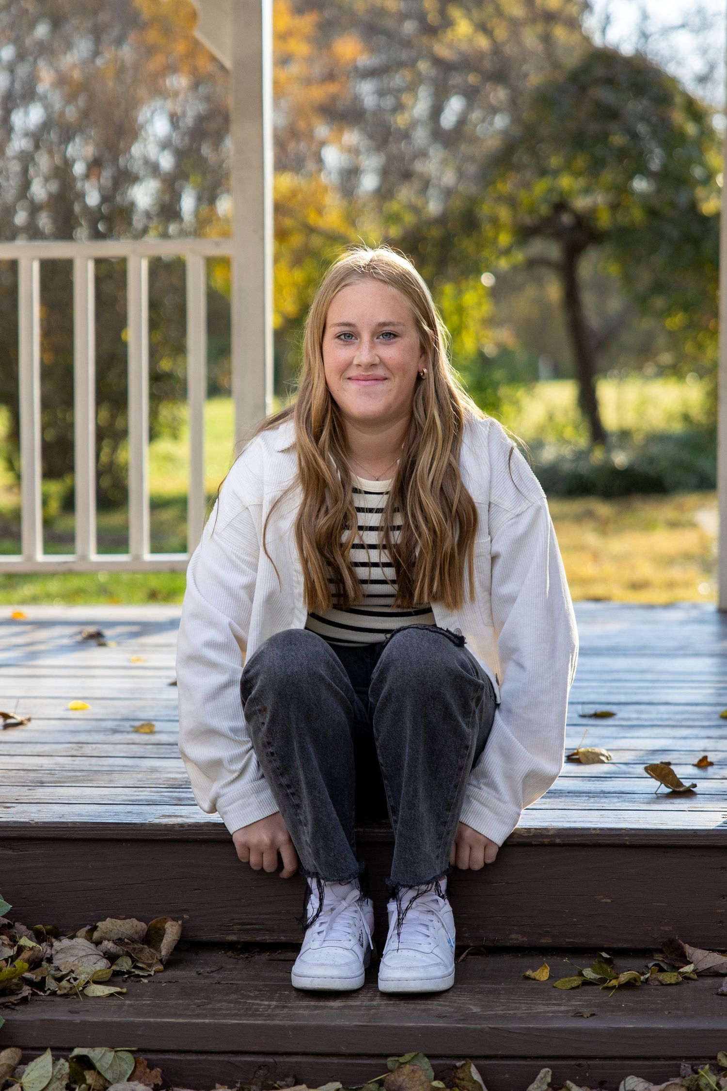 senior girl portrait with fall colors sitting on steps