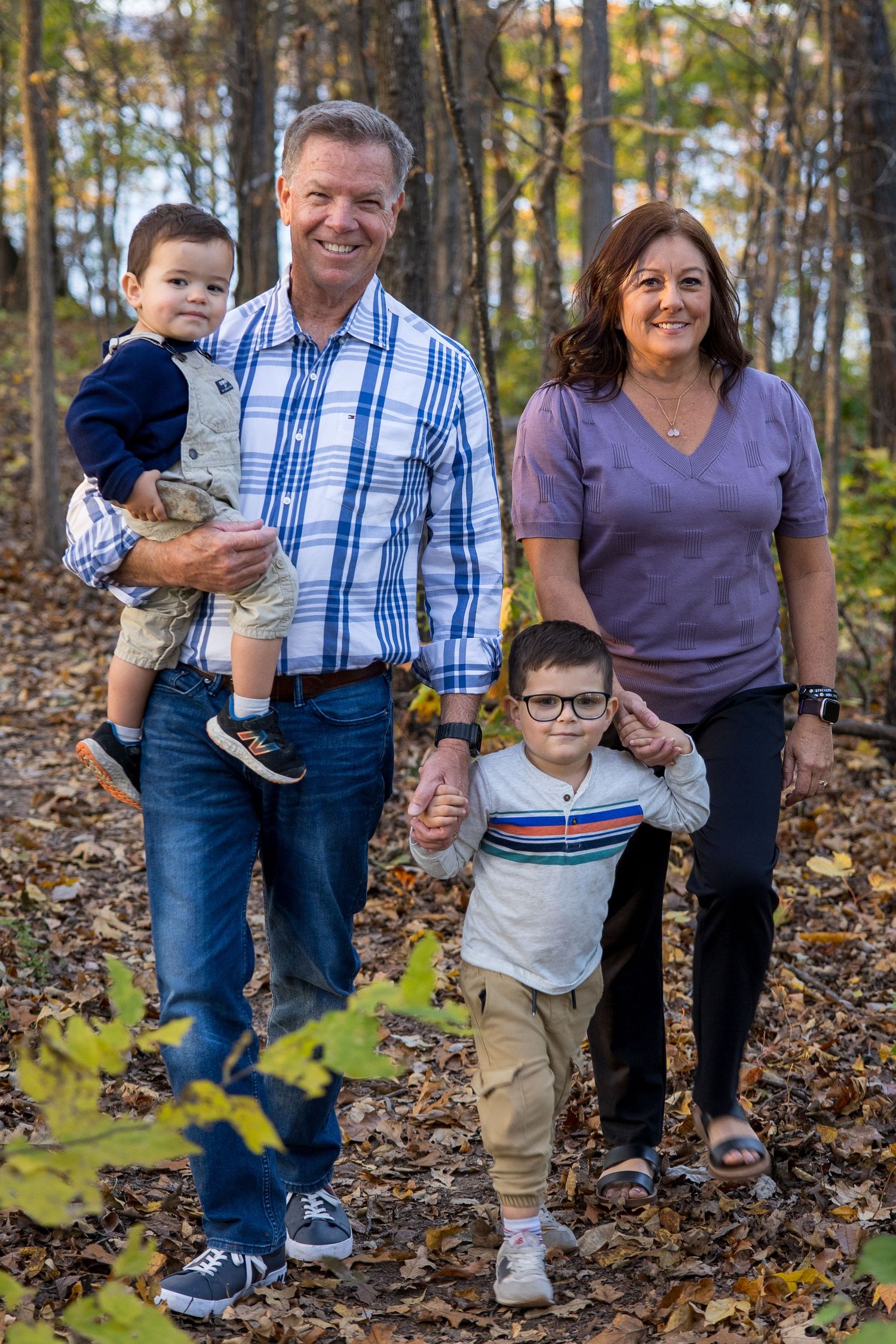 portrait of grandparents with grandkids in the woods with fall colors