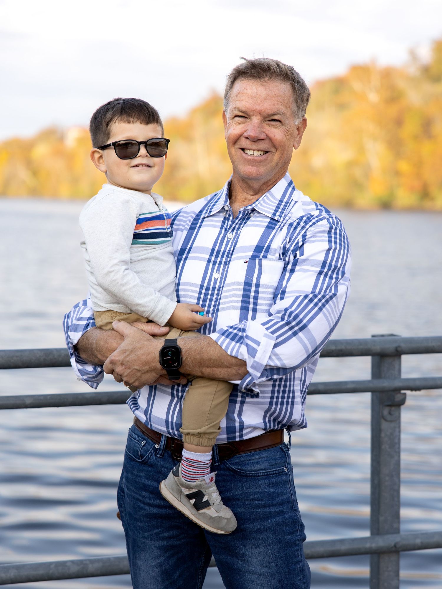 papa with 4 year old grandson at branson landing in the fall