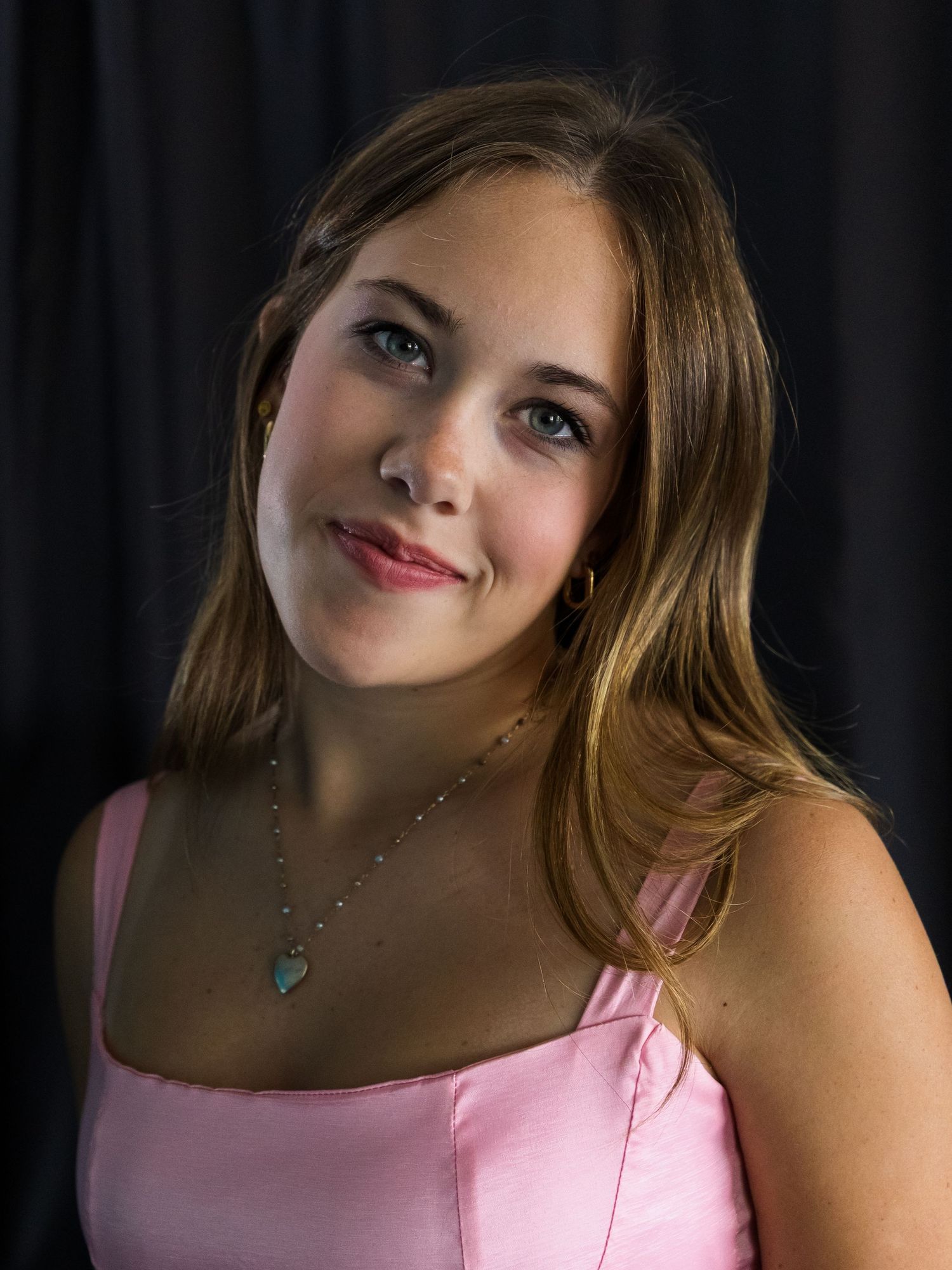 senior girl portrait pink dress with black backdrop