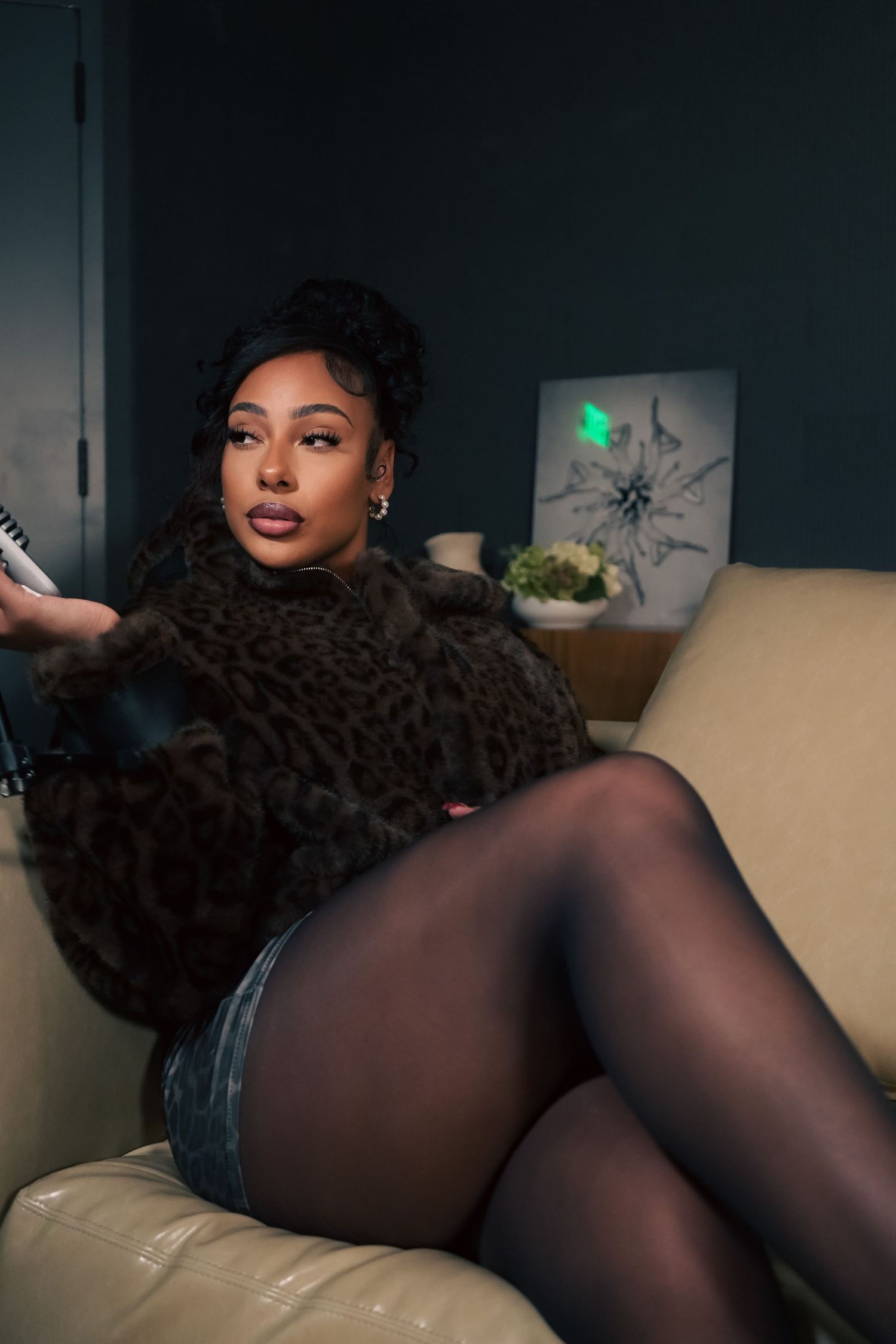 A series of intimate boudoir photos featuring a person posing on a couch in a dark room.