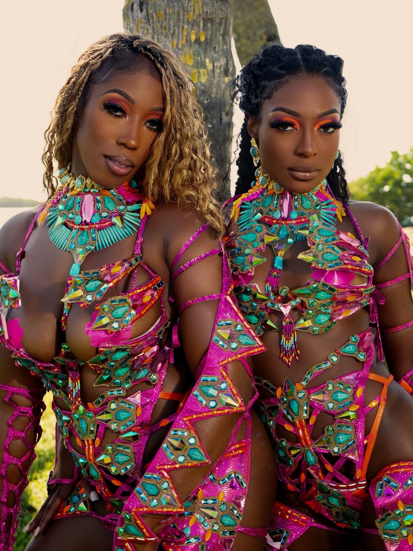Vibrant floral print dresses in pink and turquoise create a stunning visual display in multiple fashion poses.