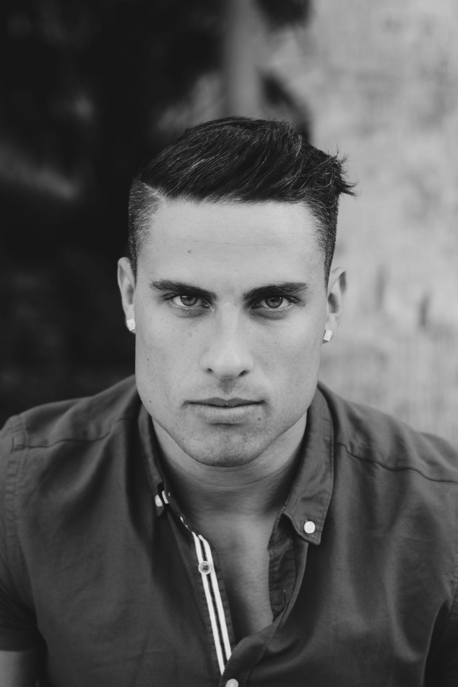 Black and white portrait showing dramatic lighting and shadows.