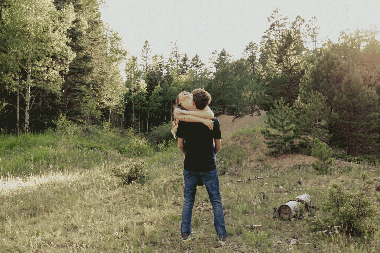 A series of outdoor photos showing someone walking through a grassy field with evergreen trees in the background.
