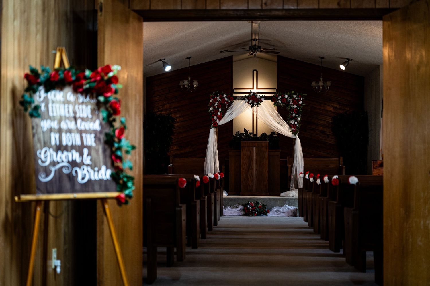 Dark church hallway decorated with Christmas lights and holiday decorations.