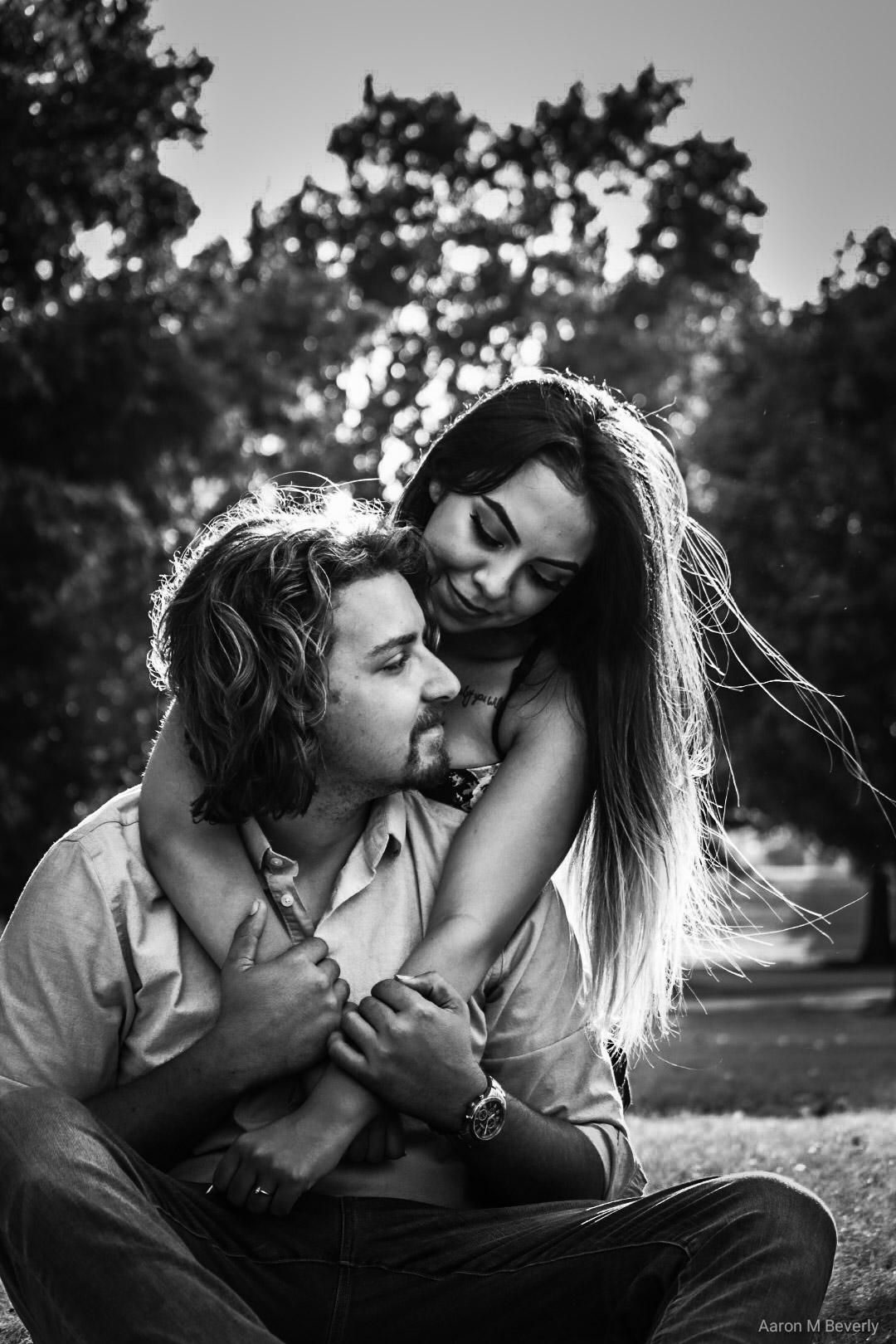 Black and white romantic photo sequence showing a couple embracing and sharing intimate moments outdoors in nature.