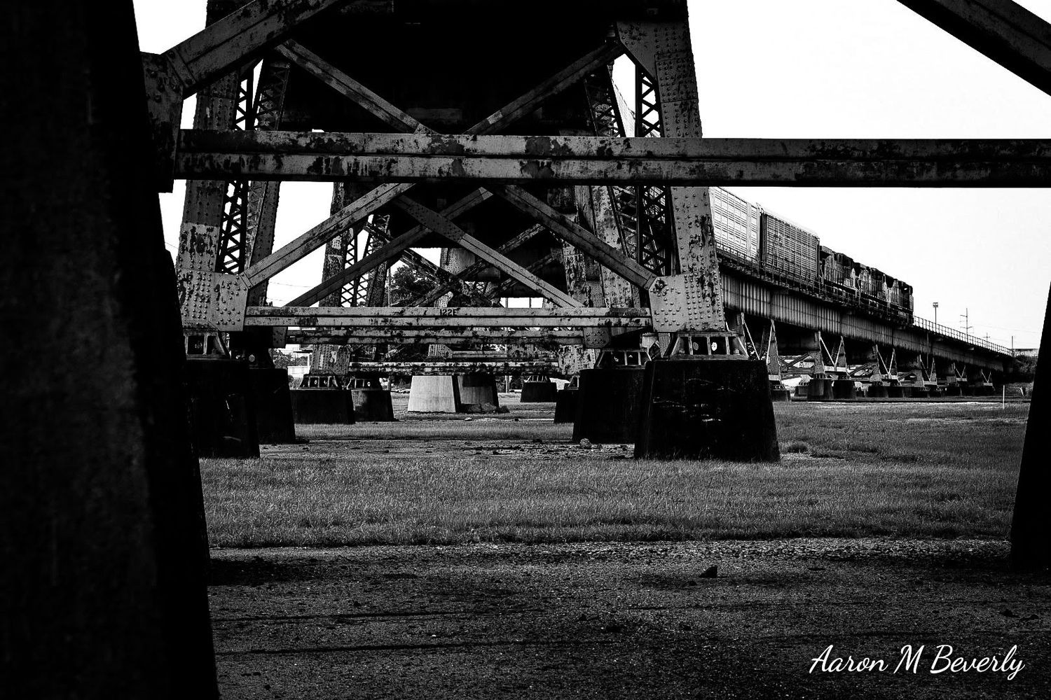 Low angle view of bridge structure in black and white creating geometric patterns.