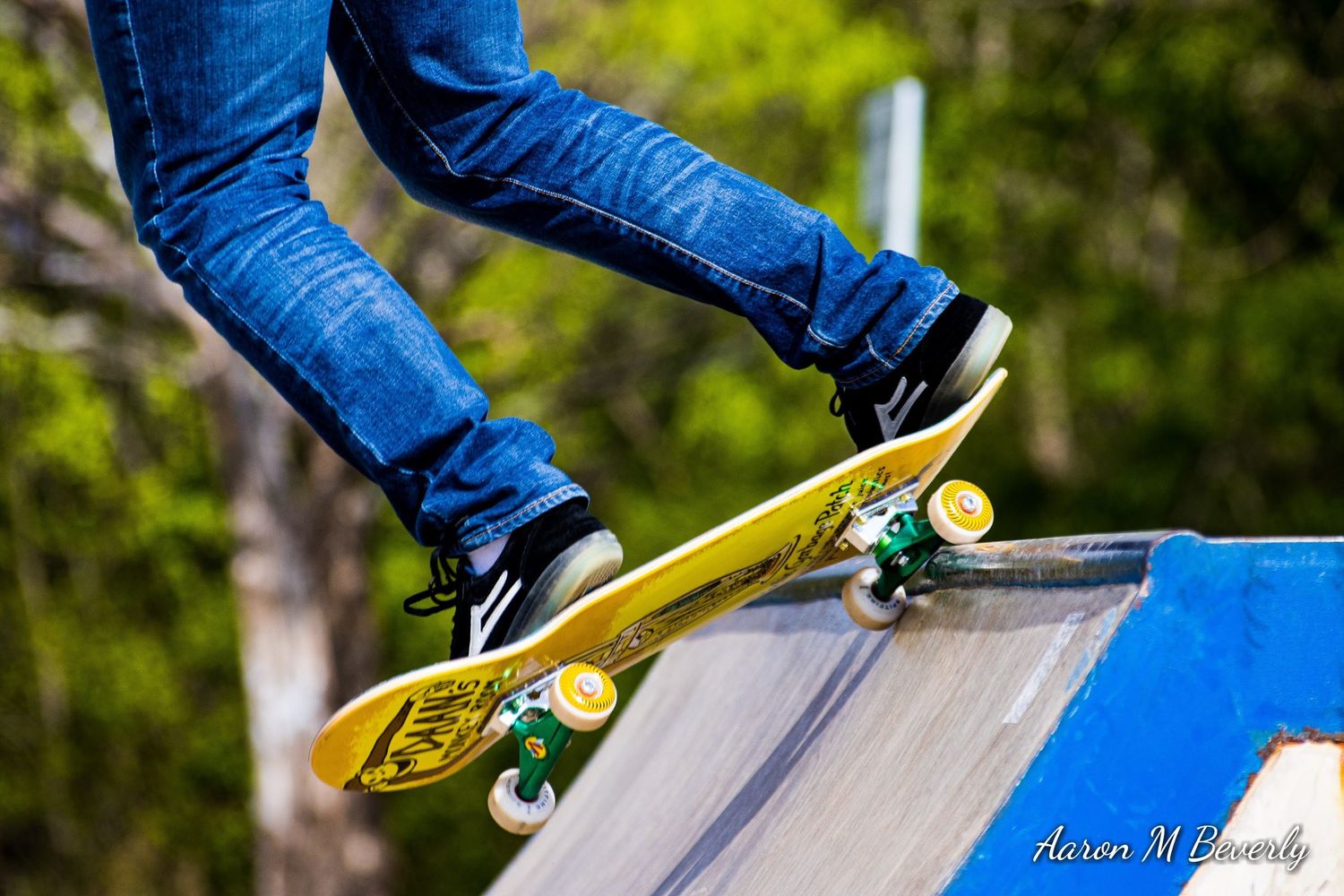 Close-up shots of skateboarding tricks showing blue jeans and yellow skateboard on a ramp.