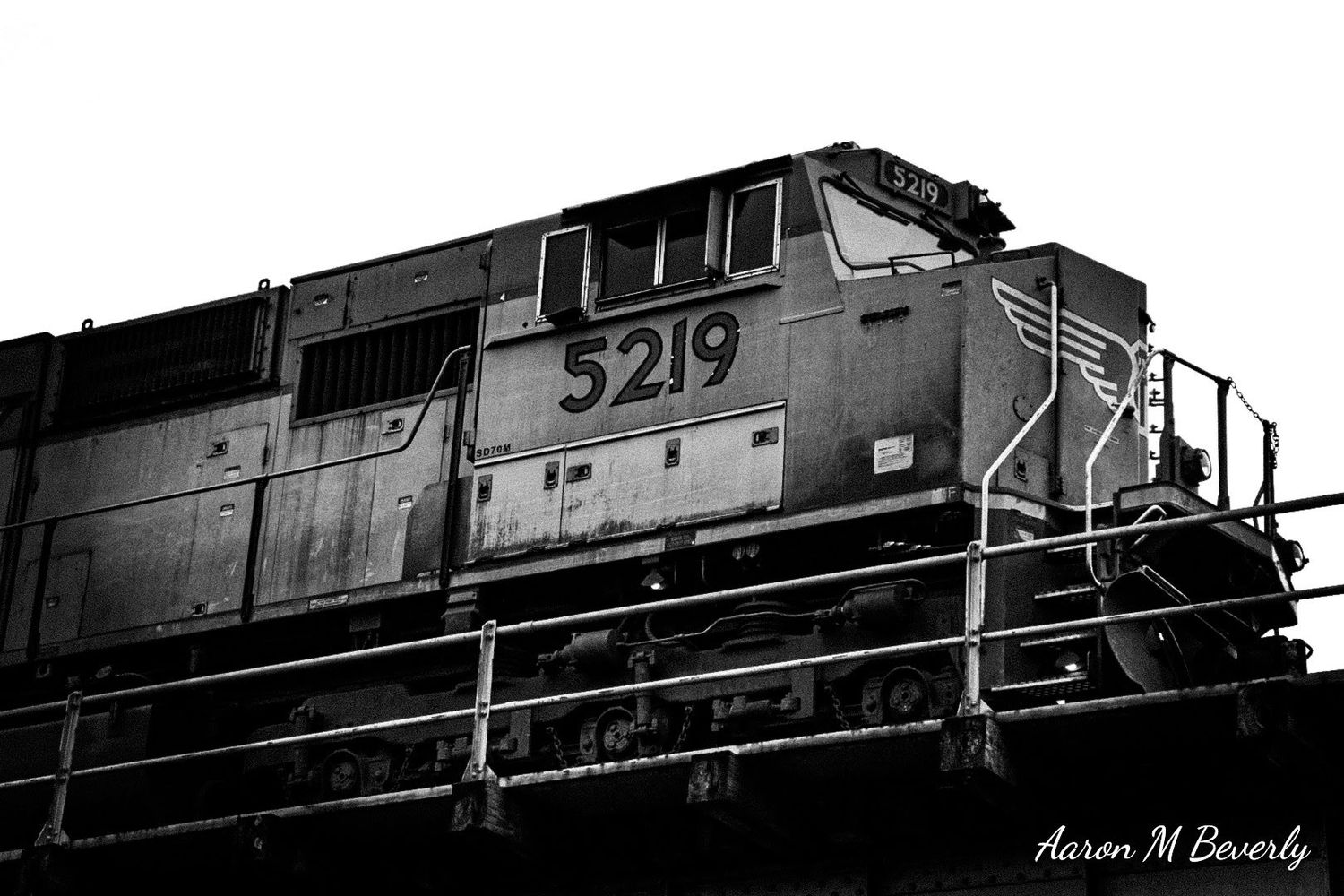 Black and white panoramic sequence of a diesel locomotive in silhouette.