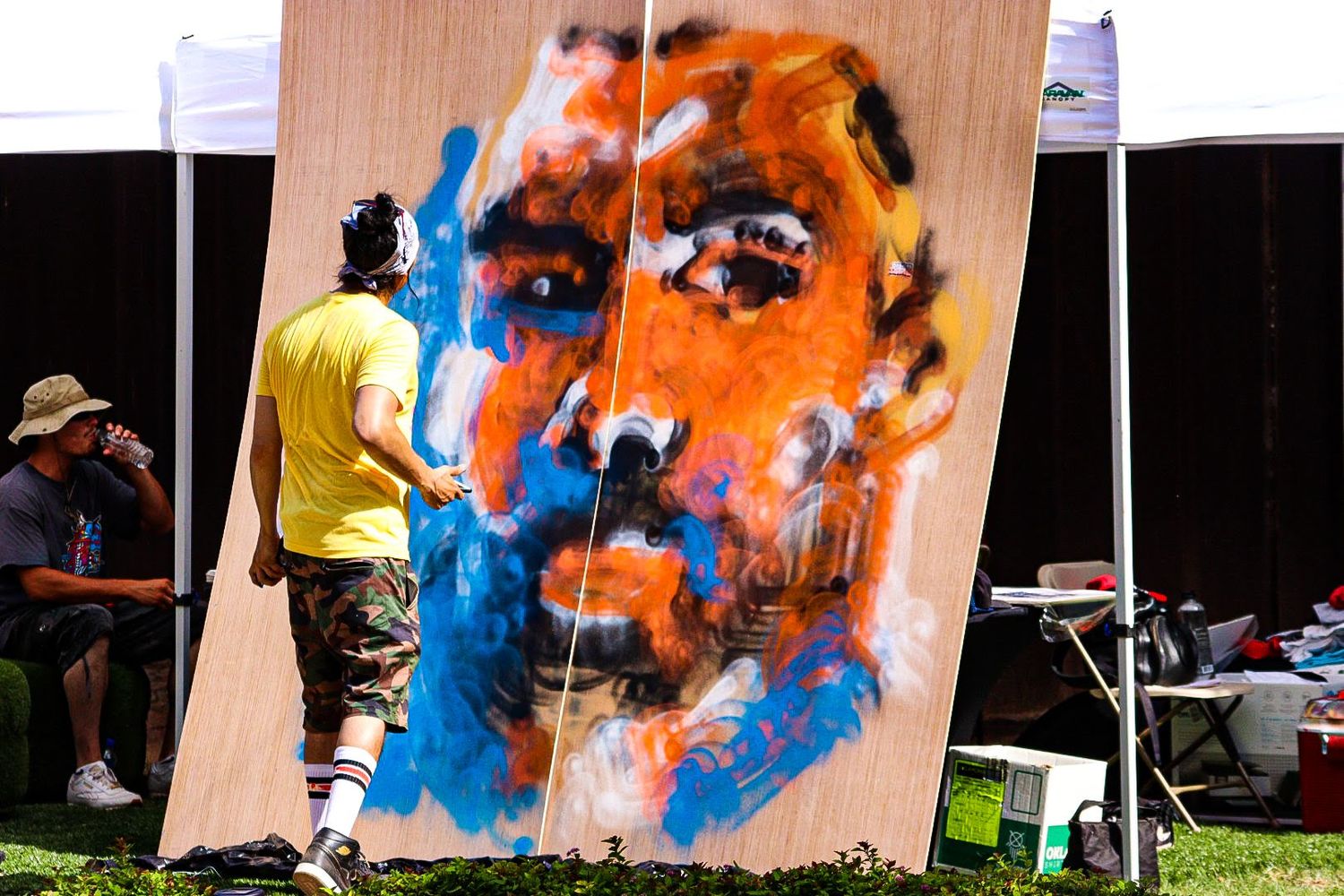 Abstract art creation sequence showing orange and blue paint splatters on a wooden surface.