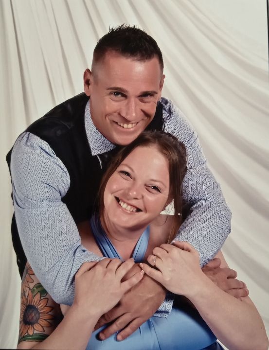 Three playful photos showing a couple embracing and laughing together against a white backdrop.