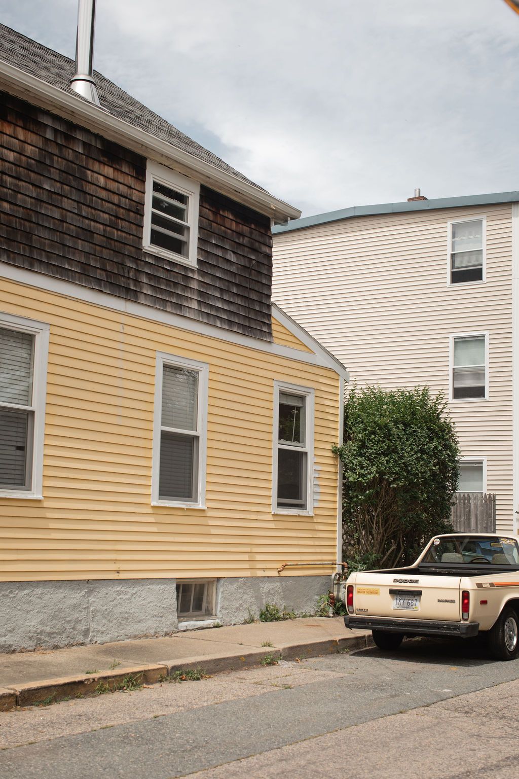 vintage yellow car near yellow house