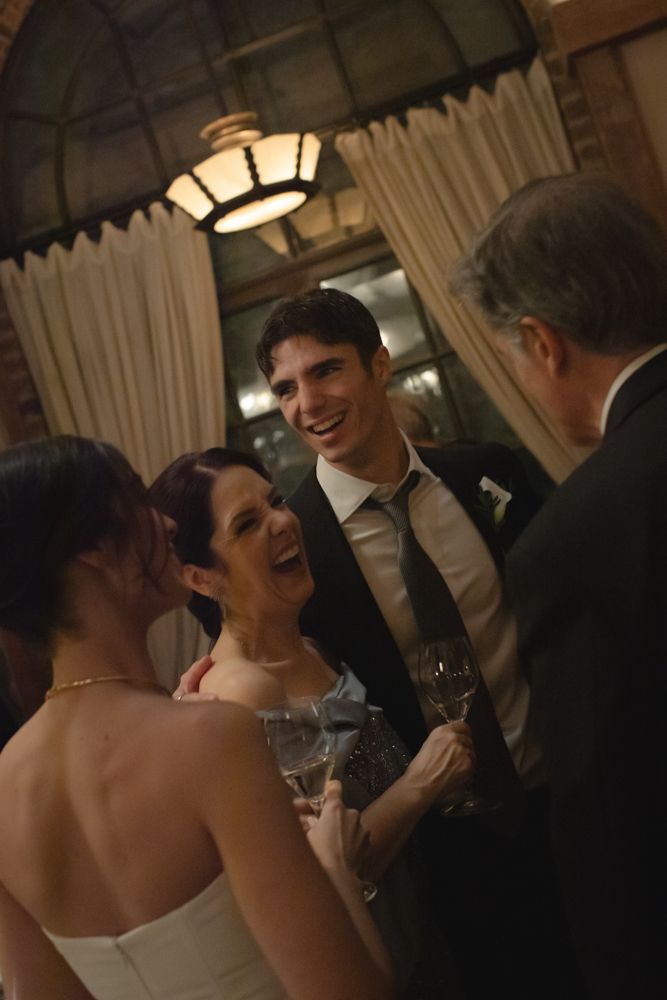 guests laughing together at wedding reception