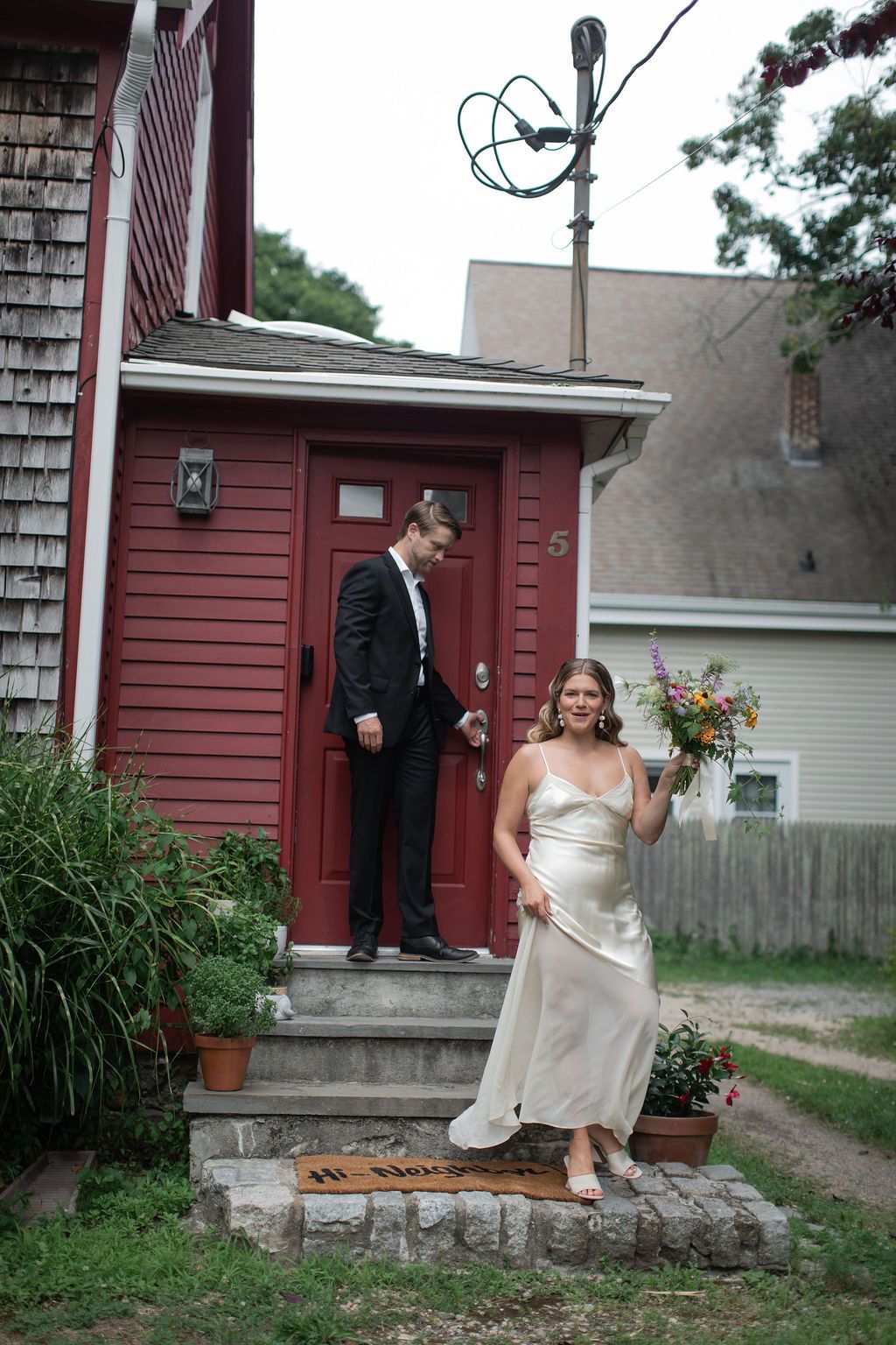 bride and groom walking out the front door together