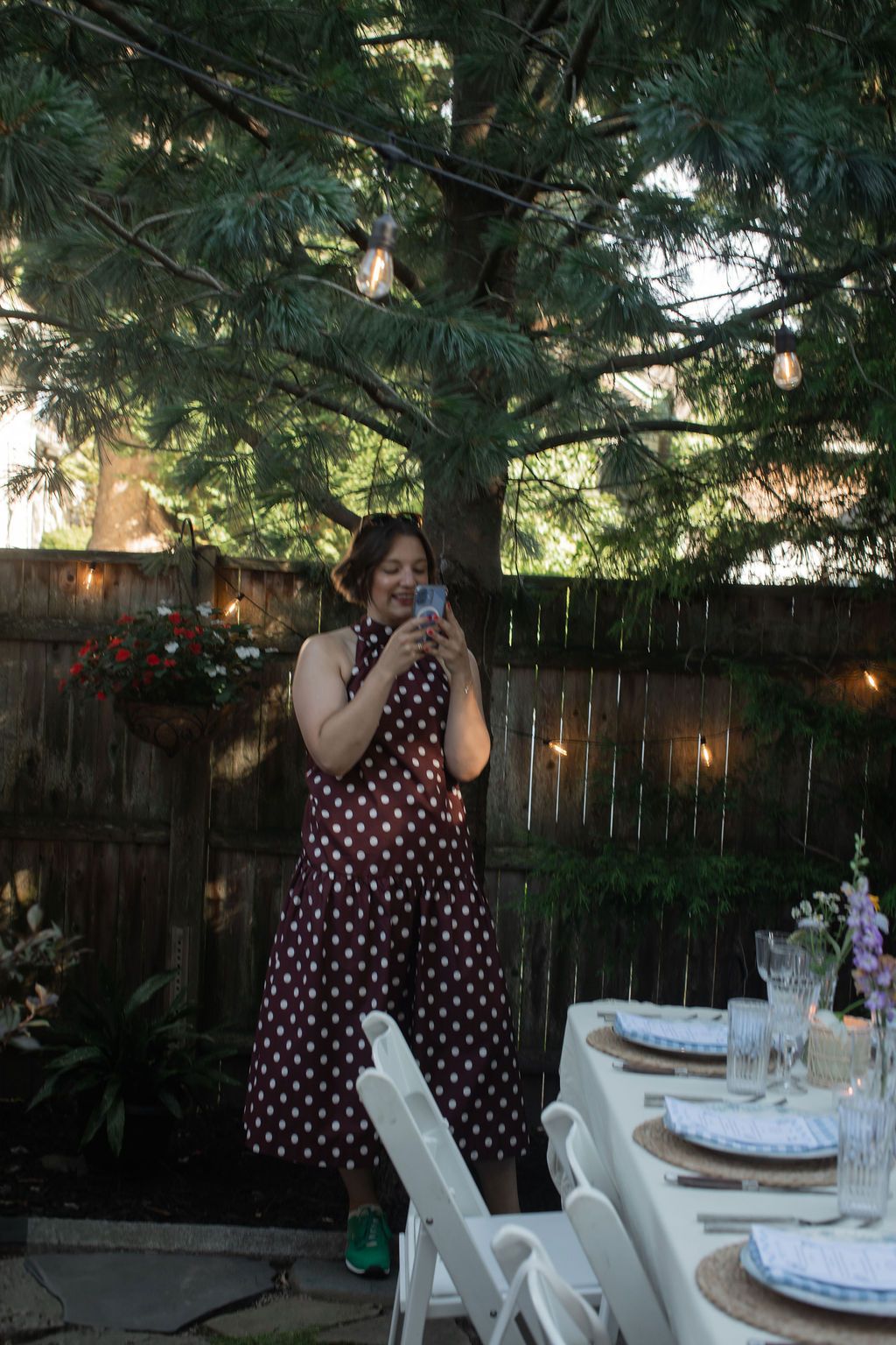 wedding guest takes a photo at backyard wedding in newport rhode island