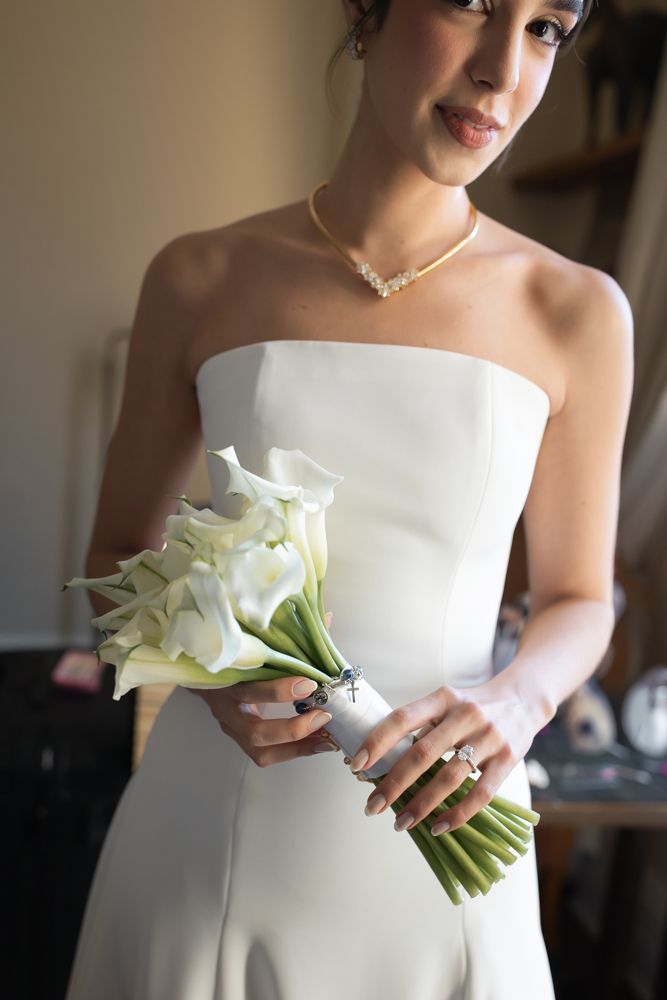 bride holding bouquet posing for photo