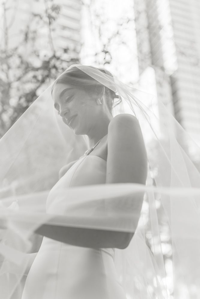 black and white photo of bride inside her veil