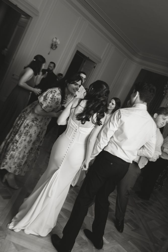 black and white photo of guests dancing at wedding reception