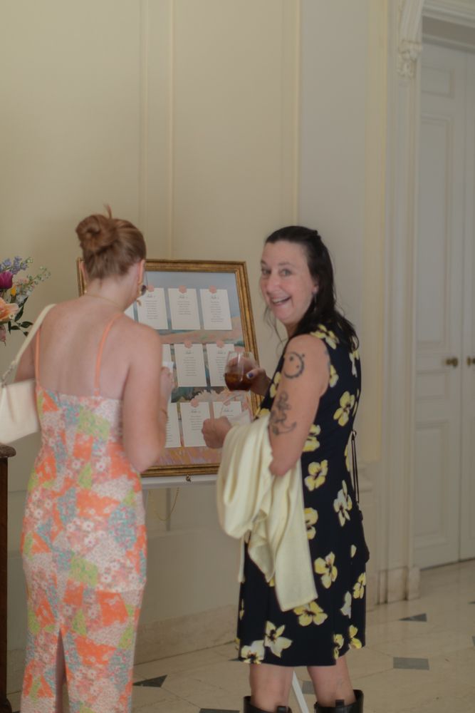 guests looking at seating chart at wedding reception