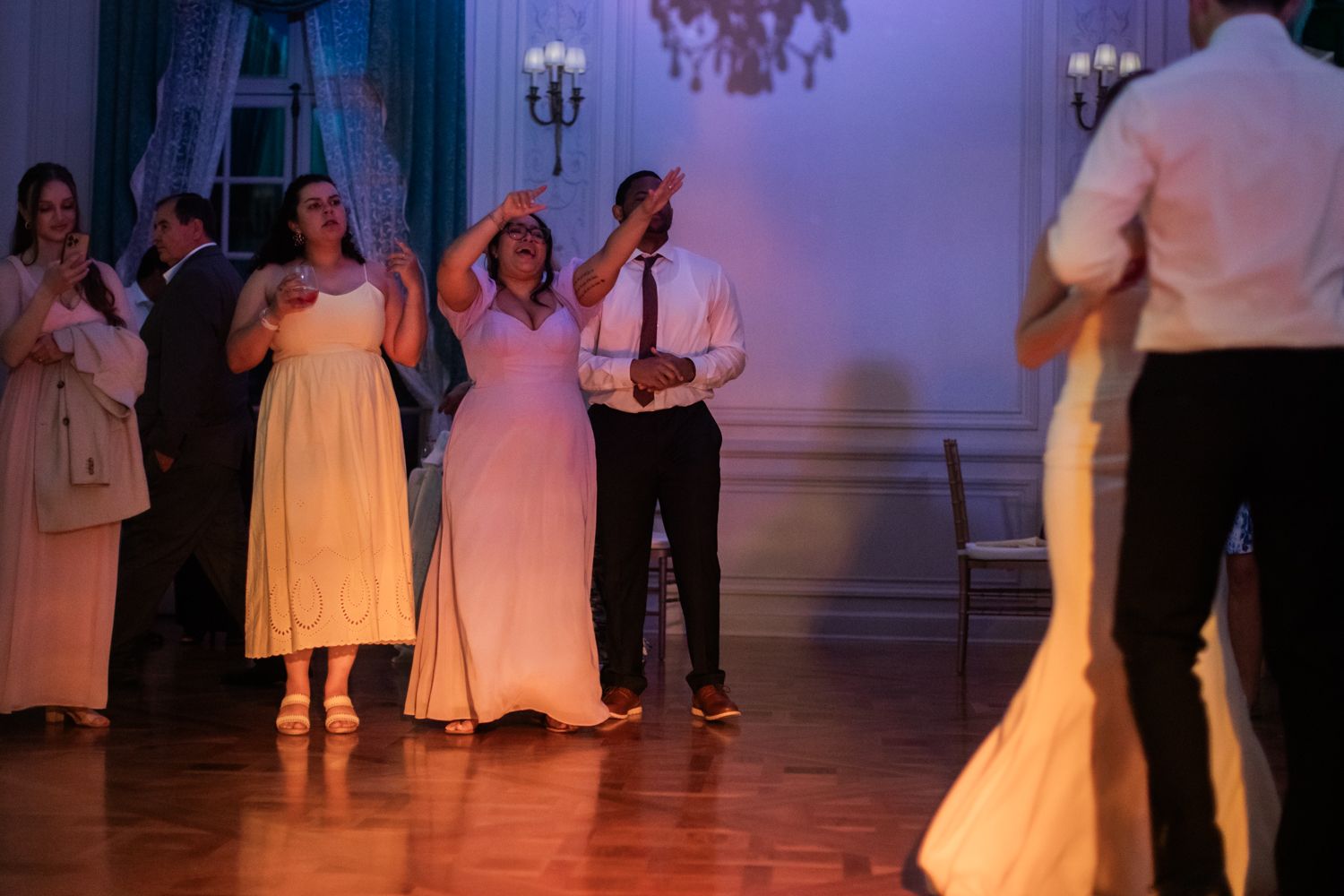 guests cheering for bride and groom at wedding reception