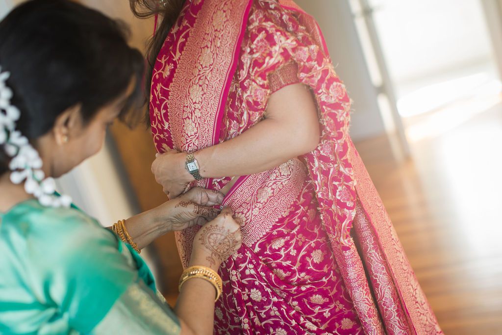 woman adjusting garments for indian wedding ceremony