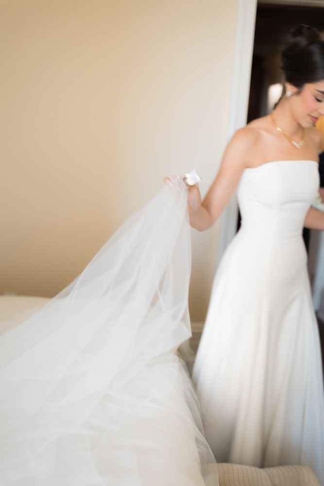 photo of bride carrying veil in hotel room in nyc
