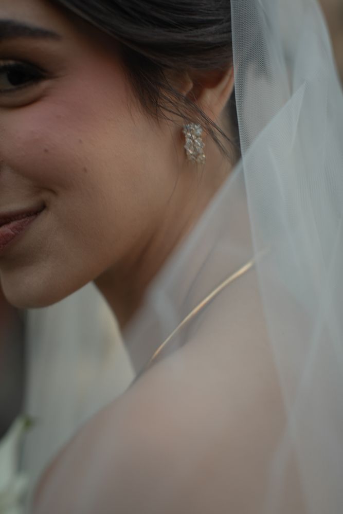 close up image of bride earrings