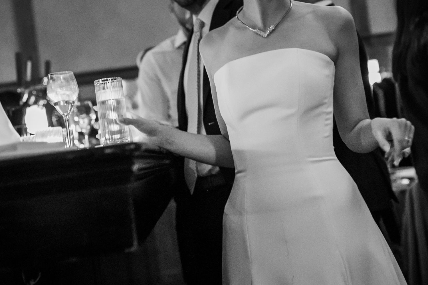 bride holding drink at the bar