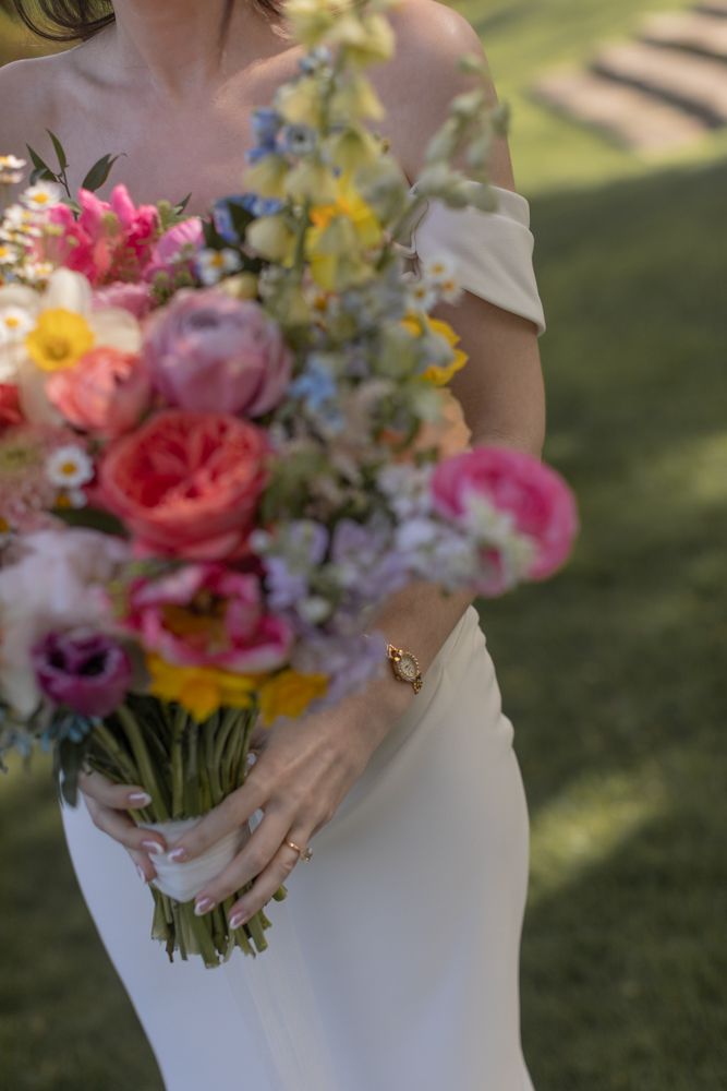 bride holding colorful bouquet