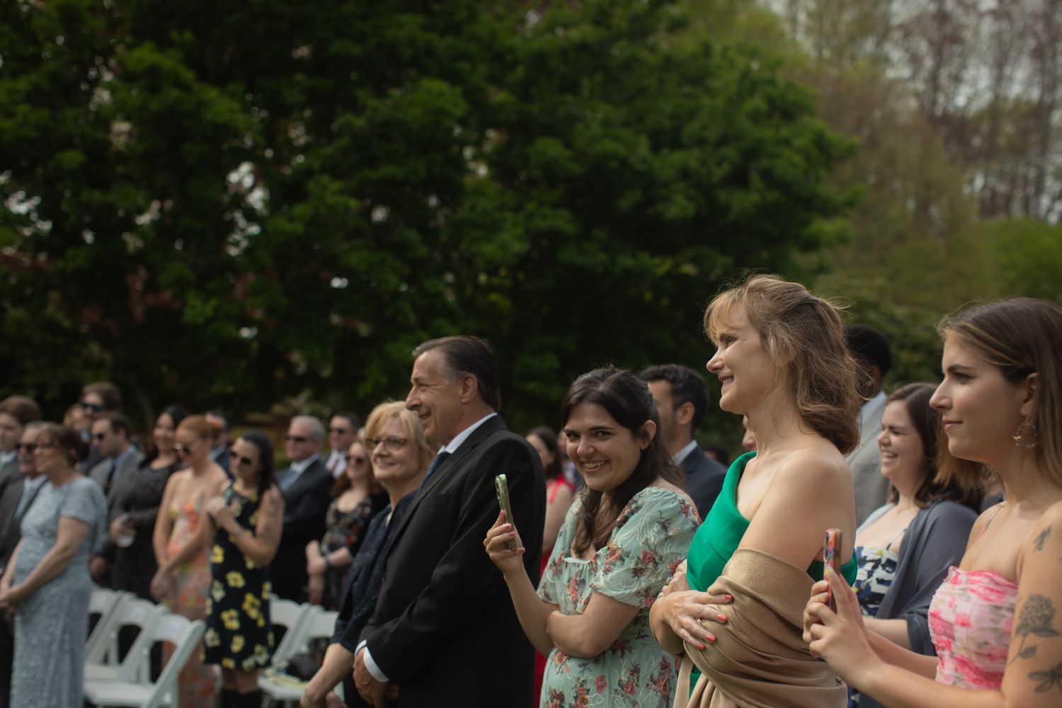 wedding guests at wedding ceremony smiling