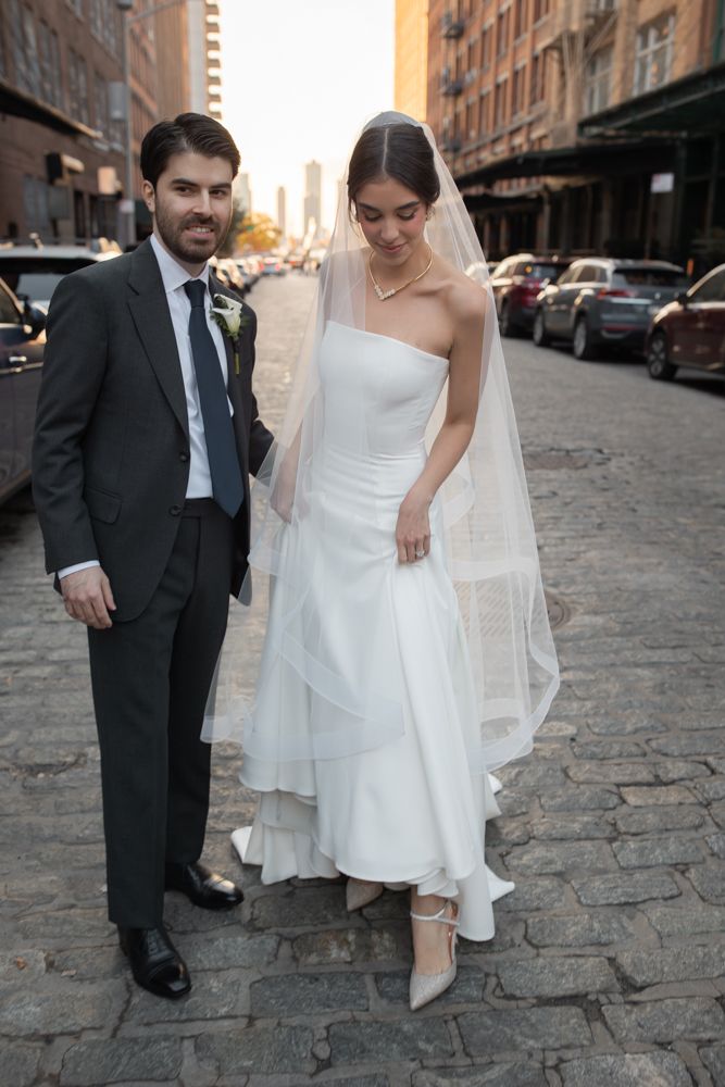 bride and groom on cobblestone