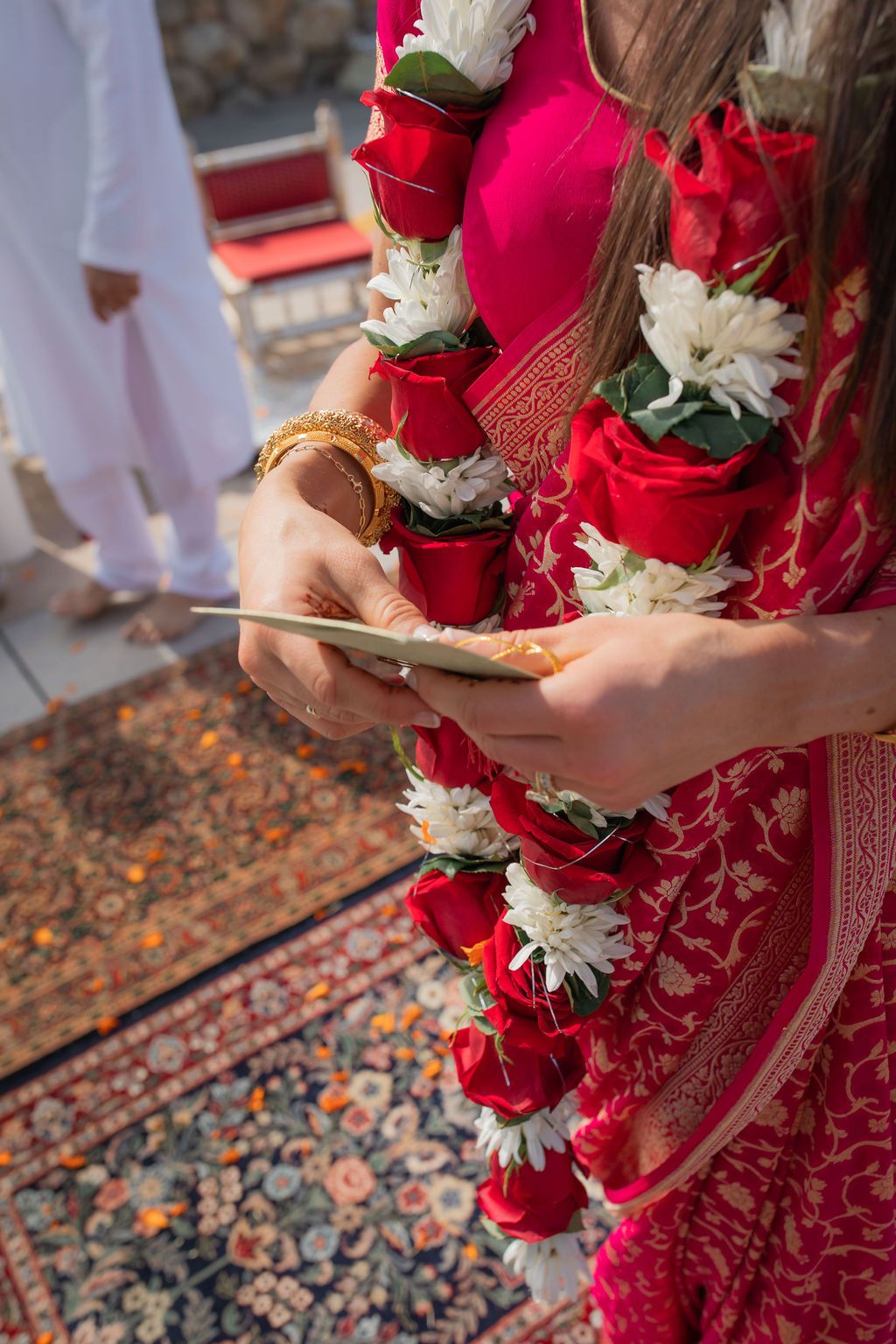 women dressed in indian sari holds card in her hands