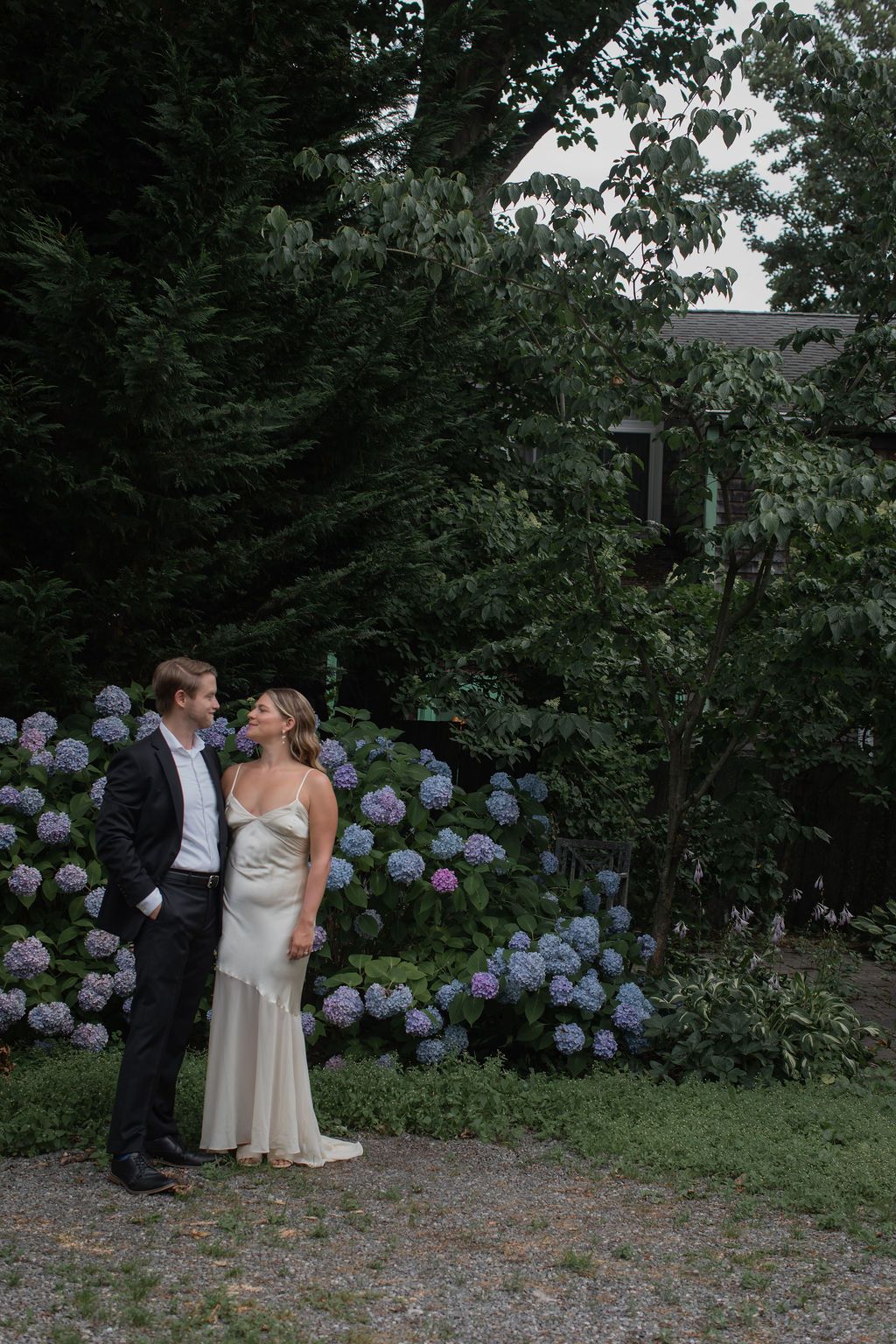 bride and groom near hydrangea bush
