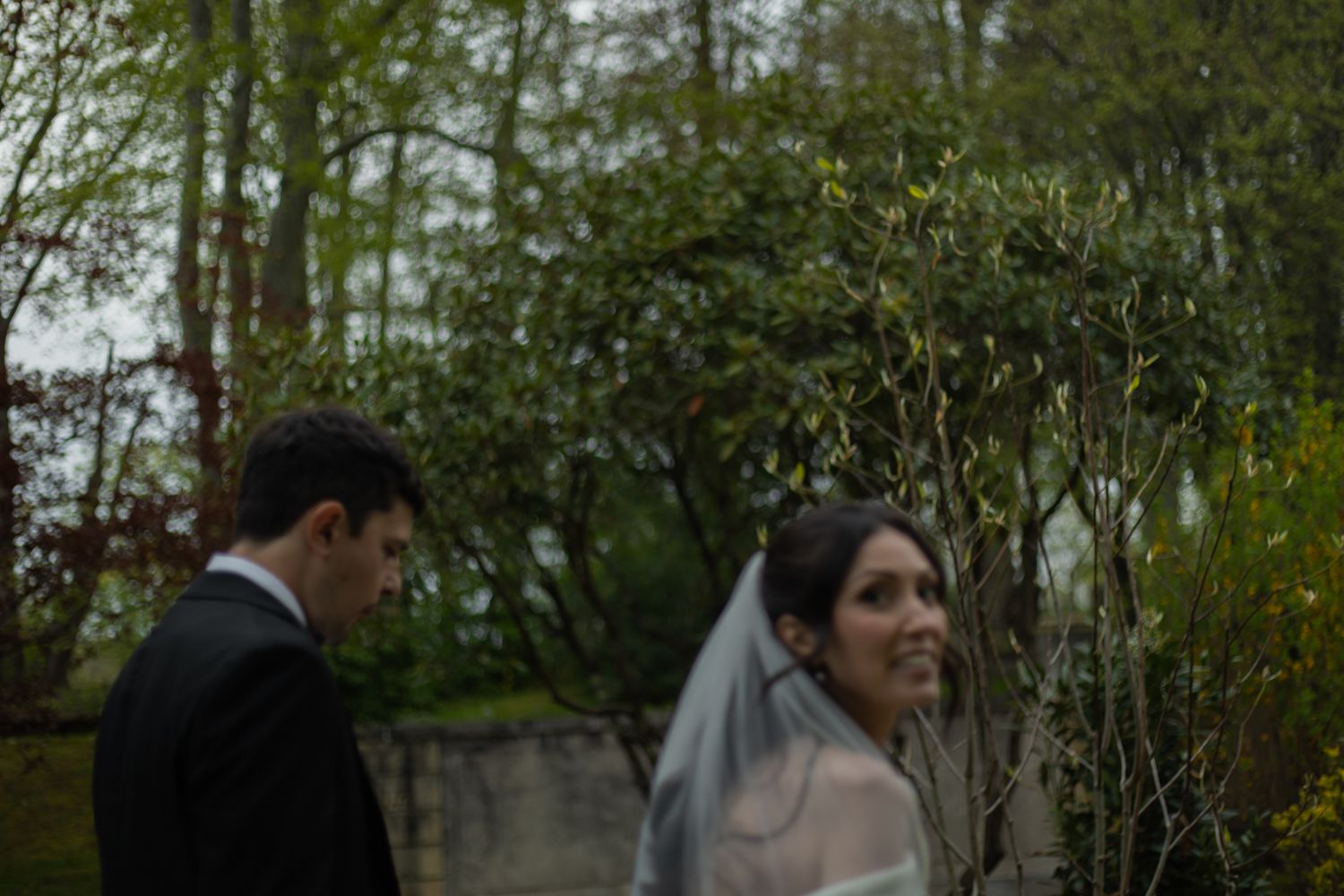 artistic photo of bride looking back at the camera and smiling