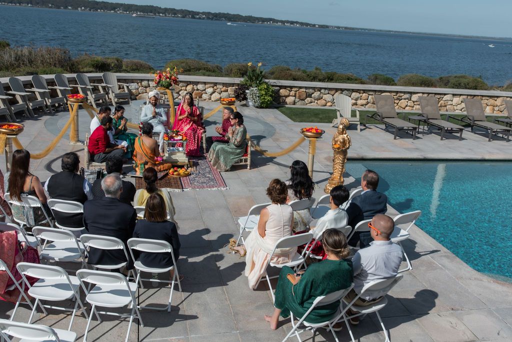 traditional indian wedding ceremony on the patio of a pool