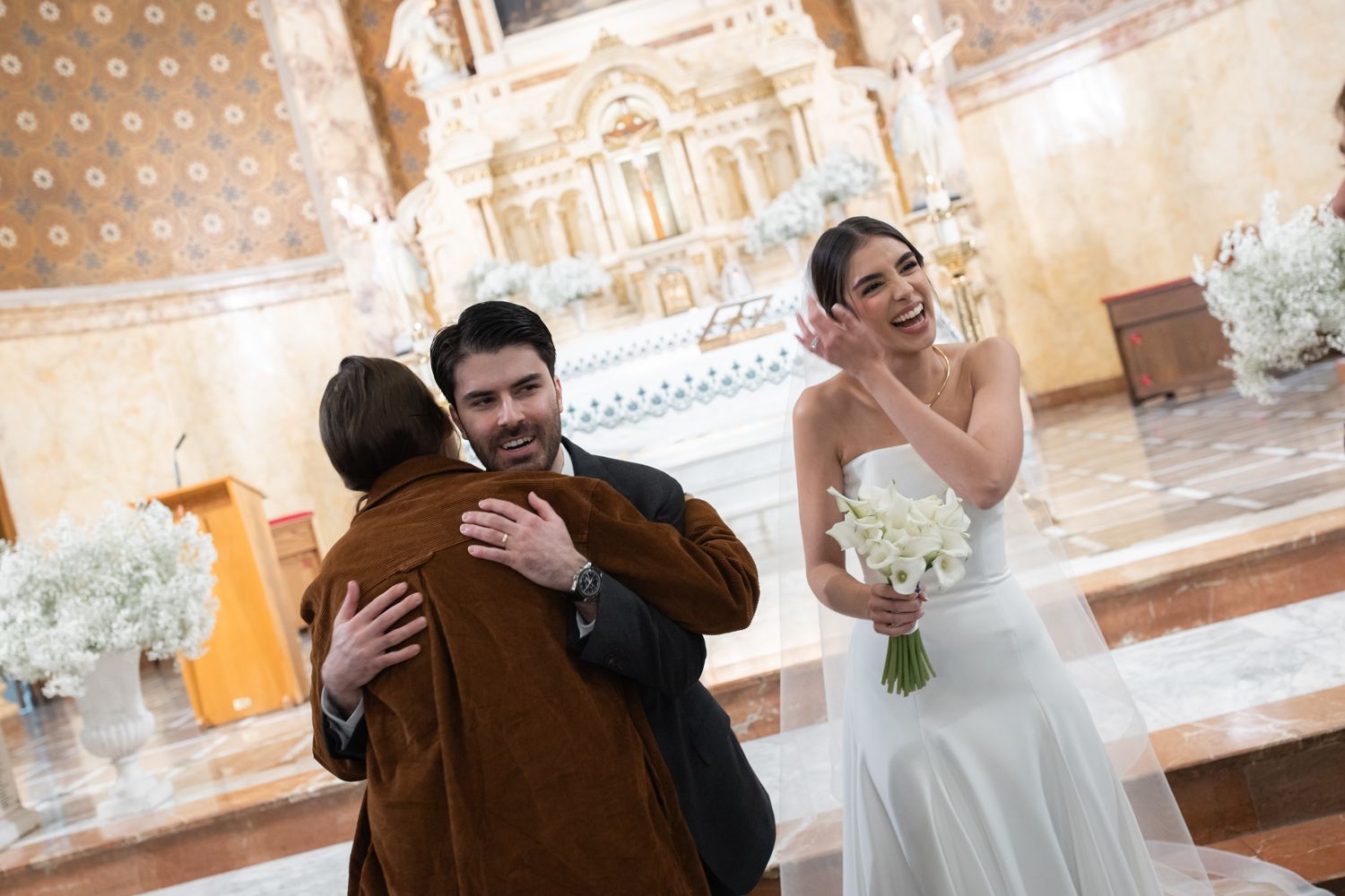 groom hugging guests at church