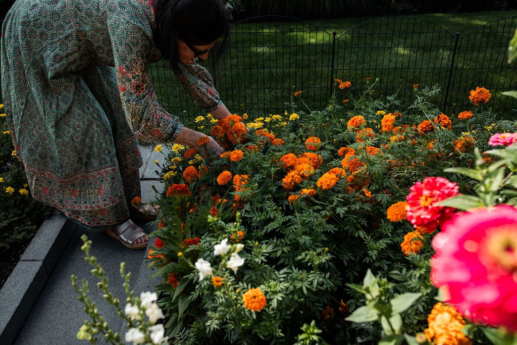 woman in green dress gardening