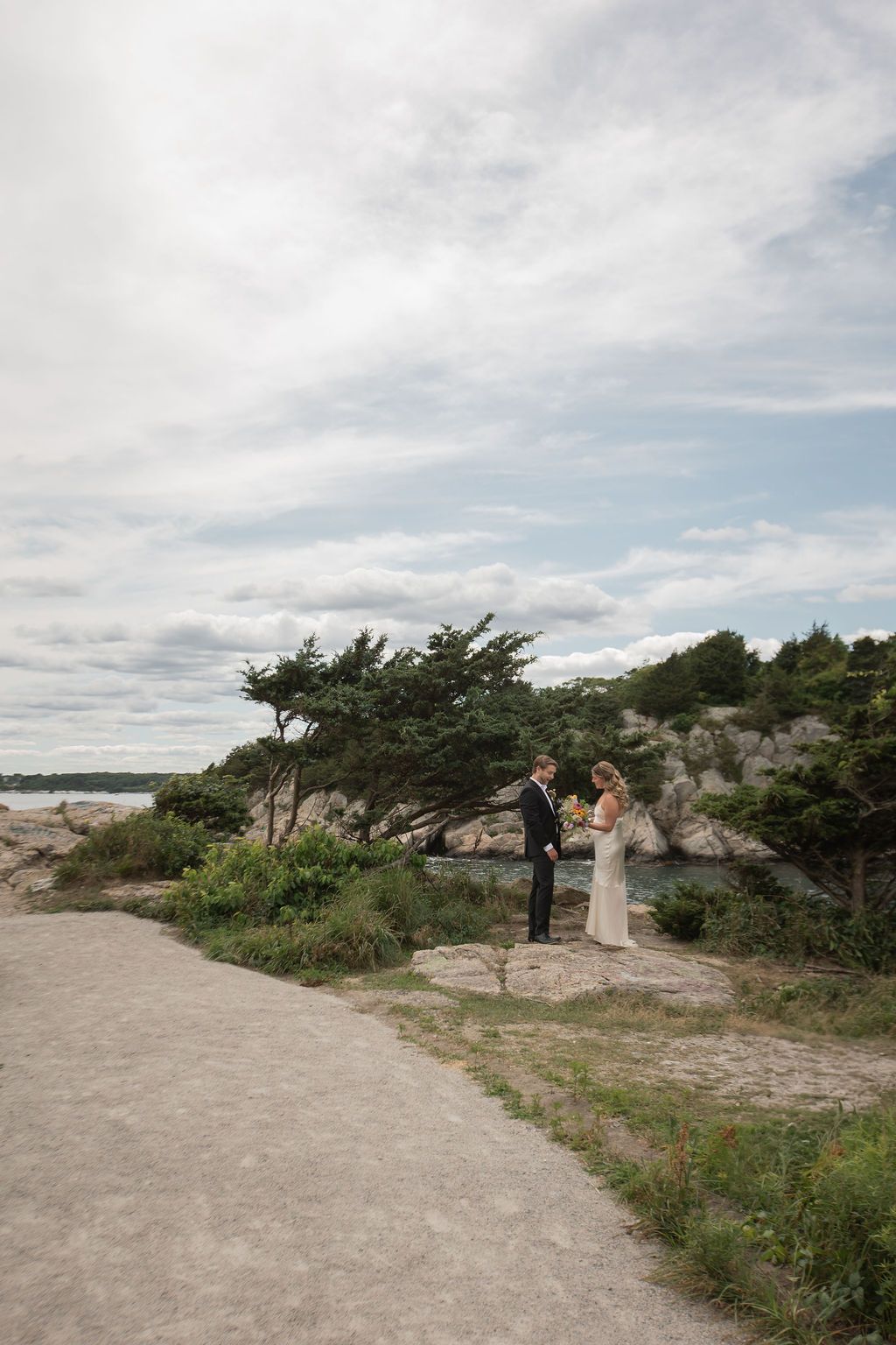 bride and groom exchanging vows at fort weatherall in jamestown, rhode island