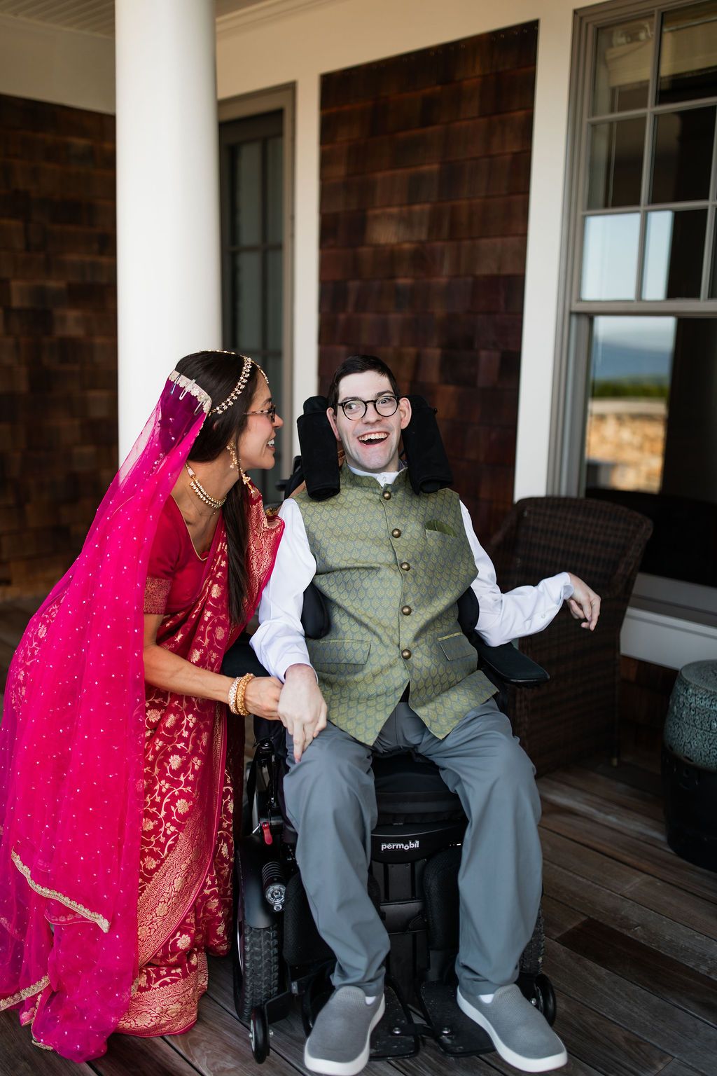 woman greets man in wheelchair joyfully