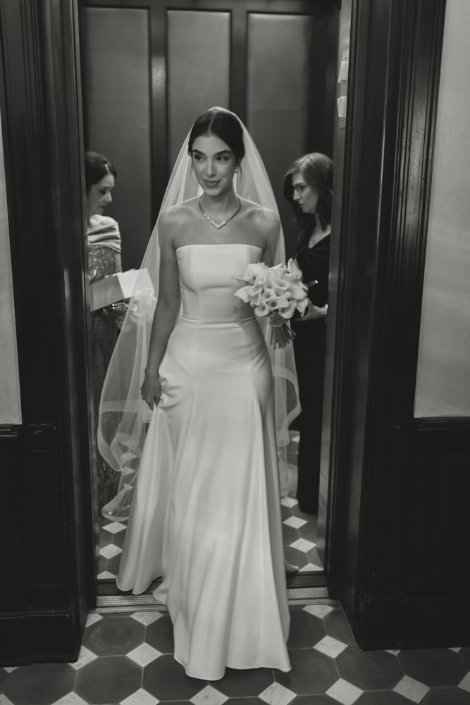 candid black and white photo of bride in elevator