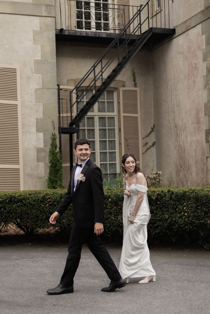 candid photo of bride and groom walking