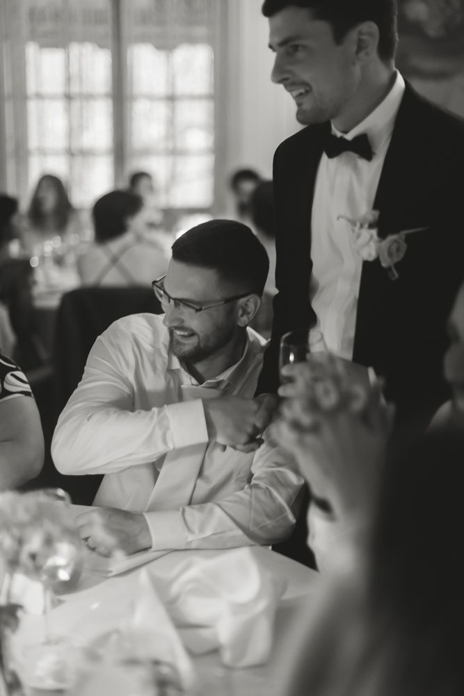groom greeting guests at tables