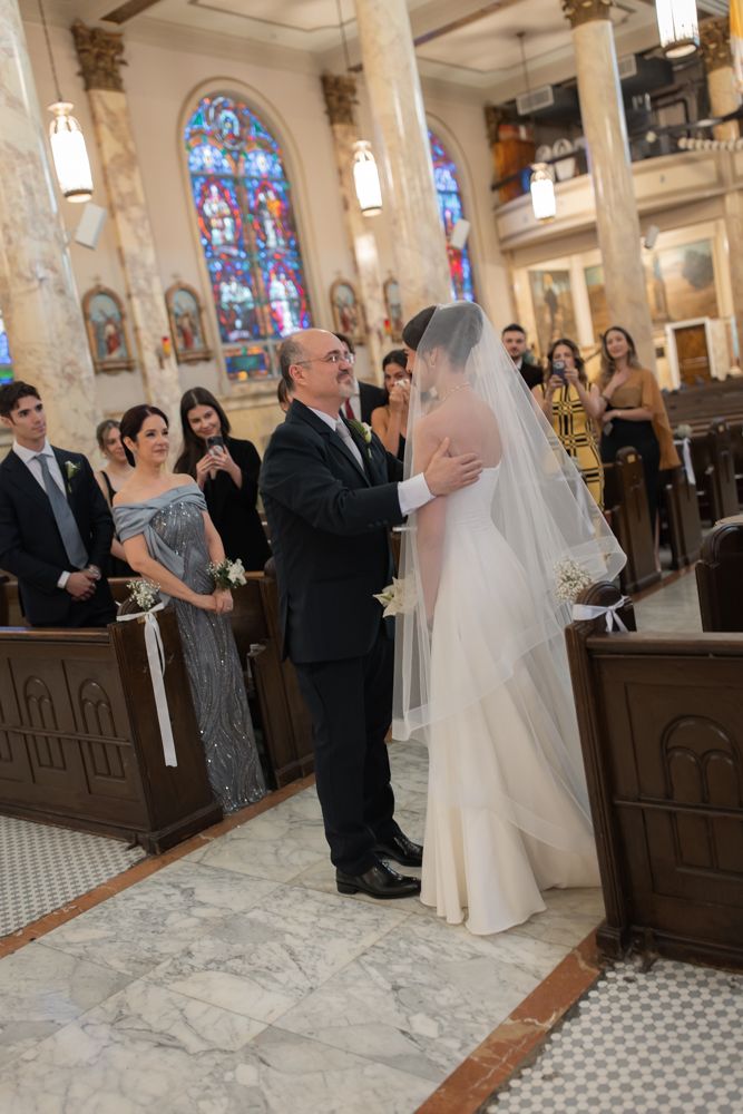 father giving bride away at the church