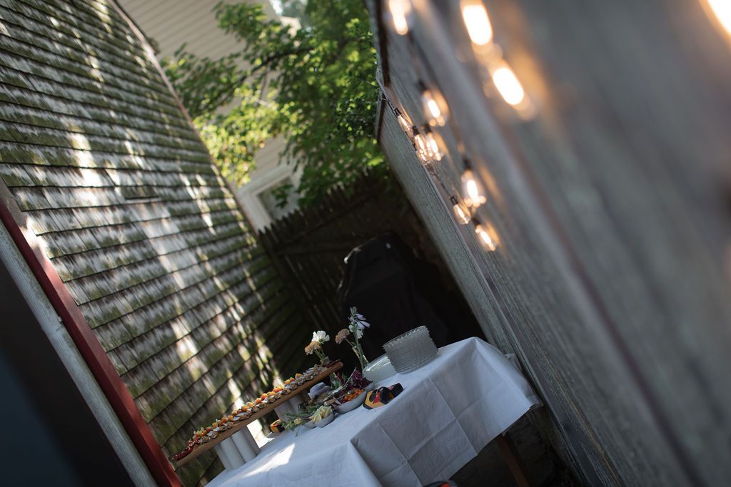 Outdoor dining area with string lights hanging overhead and wooden tables