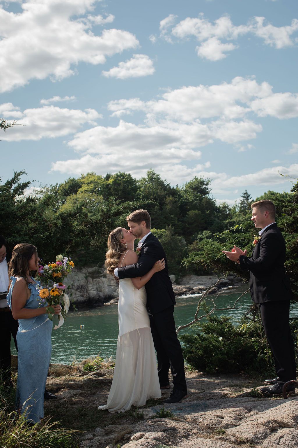 kiss at outdoor ceremony overlooking the water