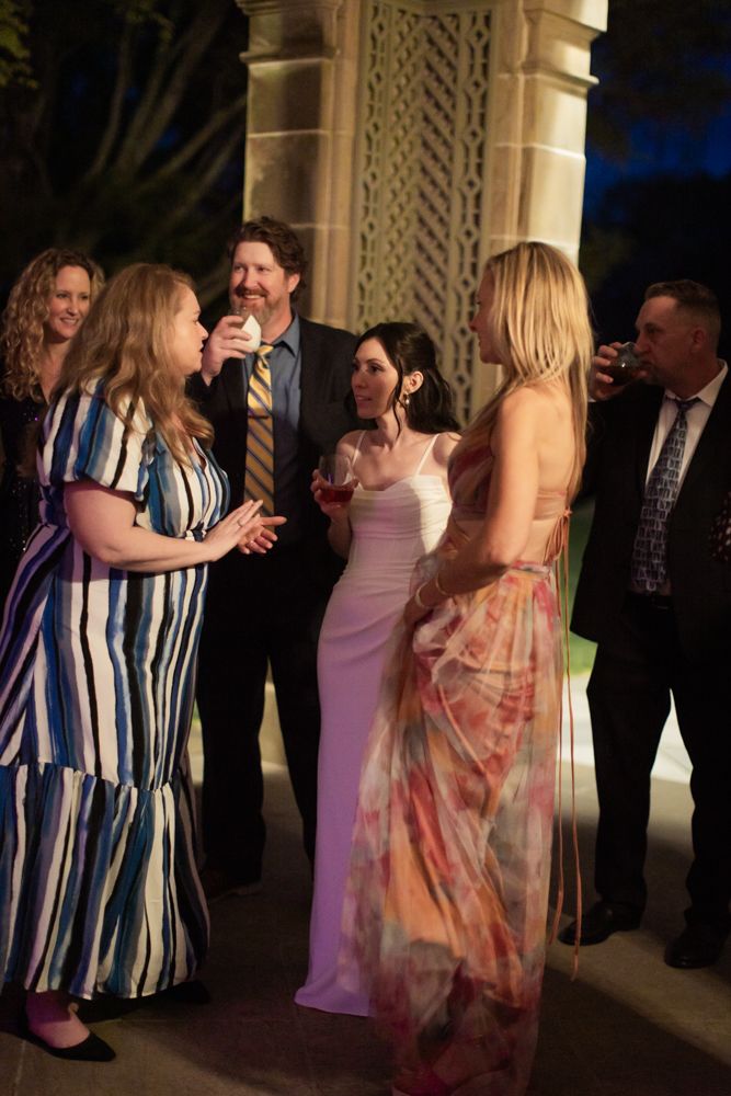 wedding guests at night under stone patio