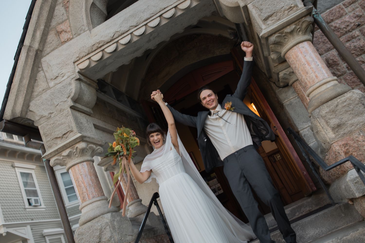 couple cheers as they exist channing church in Newport, Rhode Island