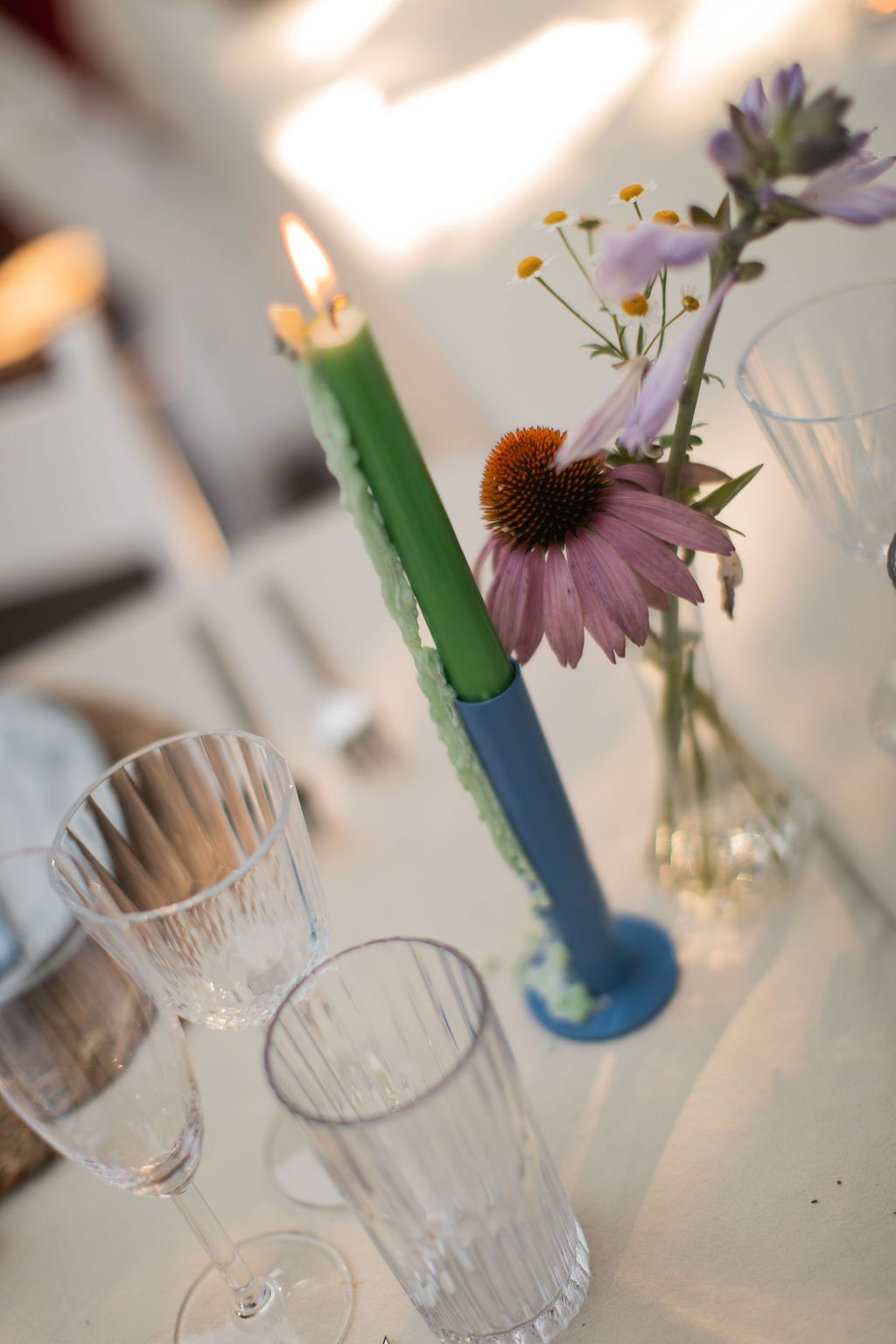 green taper candle on white linen at wedding reception in newport, rhode island